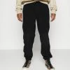 Redefined Rebel ASHER PANTS UNISEX - Tracksuit Bottoms - Black